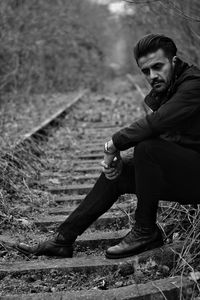 Portrait of young man sitting outdoors