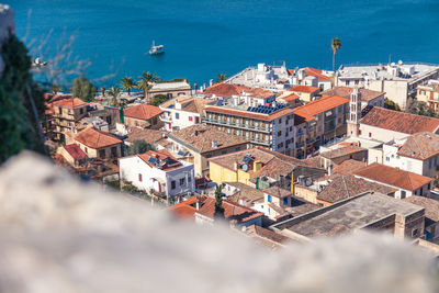 High angle view of cityscape by sea against sky