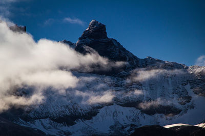 Scenic view of mountains against cloudy sky