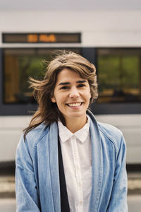 Portrait of smiling woman at tram station