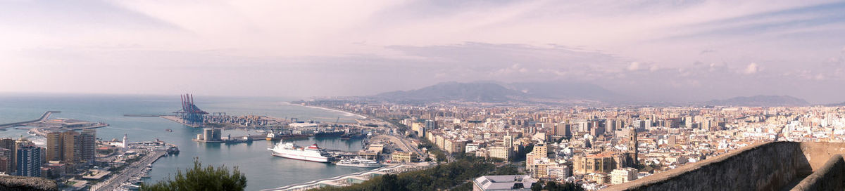 High angle view of buildings by sea against sky