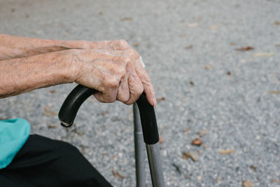 High angle view of woman holding walking cane