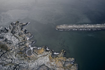 Rough shore and breakwater near sea