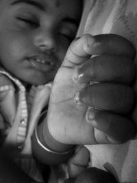 Close-up of baby holding hands