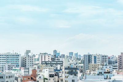 Buildings in city against sky