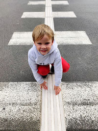 High angle view of girl standing on road