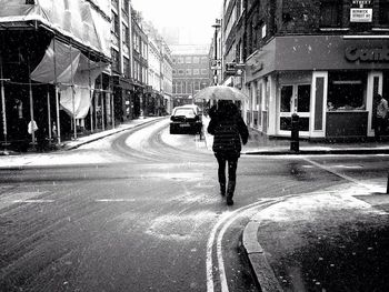 Rear view of woman walking on road