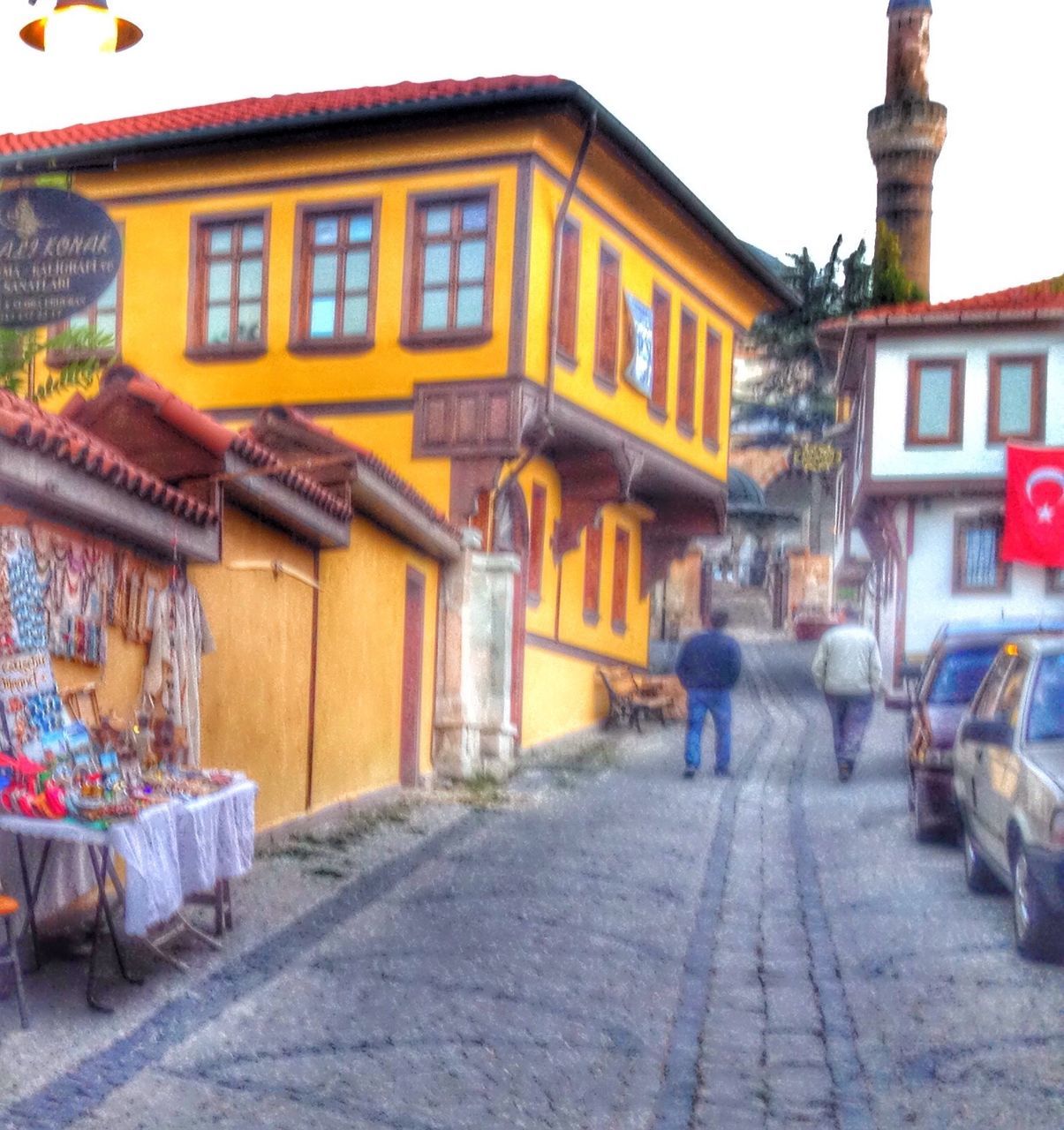 architecture, building exterior, built structure, street, incidental people, residential building, cobblestone, house, residential structure, city, outdoors, building, day, facade, potted plant, in a row, lantern, store, the way forward, sidewalk