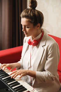 Young woman playing piano