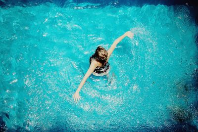 Portrait of young woman swimming in pool