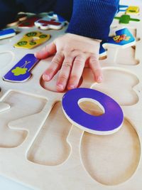 Close-up of hand holding food on table