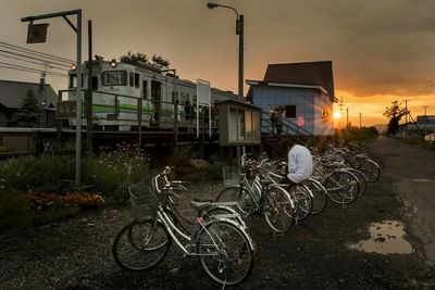 Cars parked on road at sunset