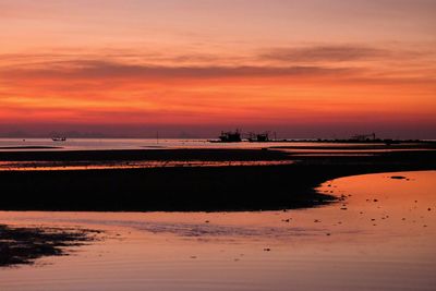 Scenic view of beach against sky during sunset