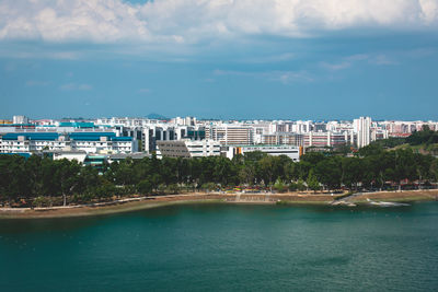 Scenic view of sea by buildings against sky