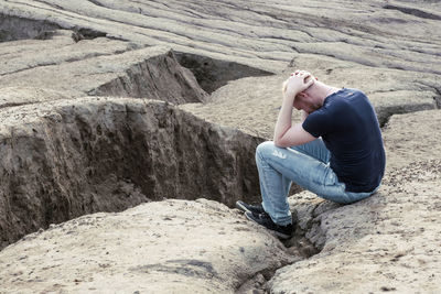 Man sitting on rock