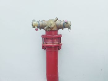 Close-up of fire hydrant against wall