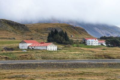 Houses on mountain against sky