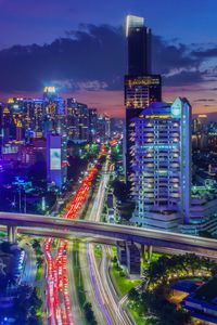 High angle view of illuminated buildings in city at night