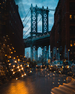 Illuminated street amidst buildings in city at night