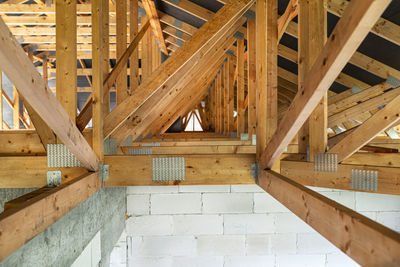 Roof trusses covered with a membrane on a detached house under construction, view from the inside,