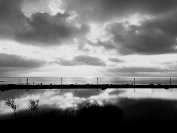 Scenic view of sea against cloudy sky