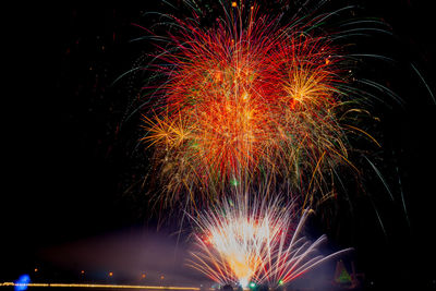 Low angle view of firework display at night