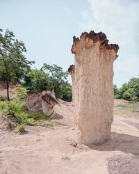 View of old ruin on field against sky