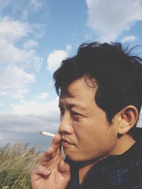 Portrait of man looking away against sky
