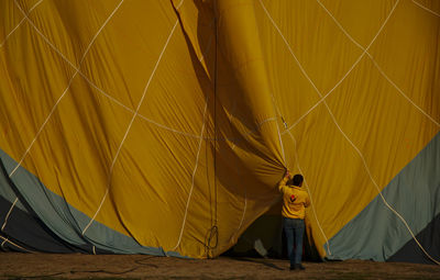 Rear view of man with hot air balloon