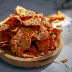 Close-up of indonesian basreng meatball chips served in plate on marble table