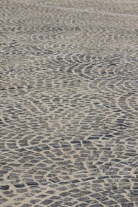 High angle view of footprints on sand at beach