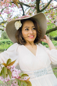 Portrait of young woman wearing hat