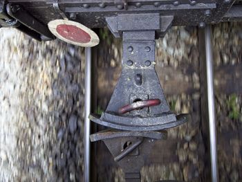 Close-up of shoes hanging on metal wall