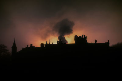 Silhouette buildings against sky during sunset