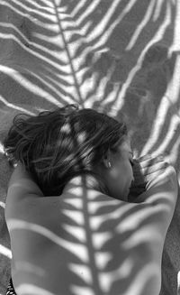 High angle view of girl relaxing on bed