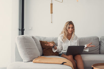 Young woman using laptop at home