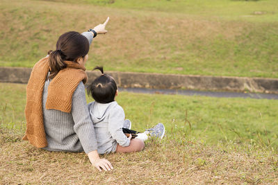 Woman sitting with toddler pointing