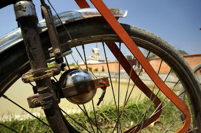 Close-up of rusty wheel against clear sky