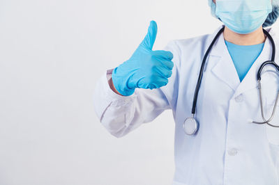 Midsection of person wearing hat against white background