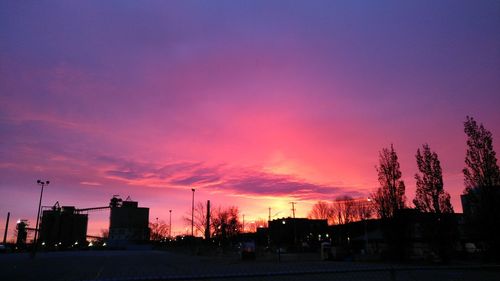 Silhouette city against sky at sunset