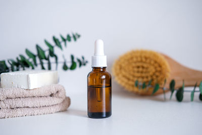 Close-up of beauty products against white background