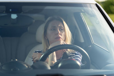 Portrait of woman sitting in car