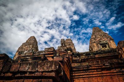 Low angle view of temple against cloudy sky