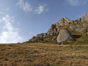 Rock formations on land against sky