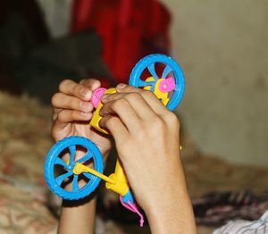 Cropped hands of child holding toy