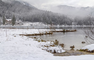 Scenic view of snow covered mountains against sky