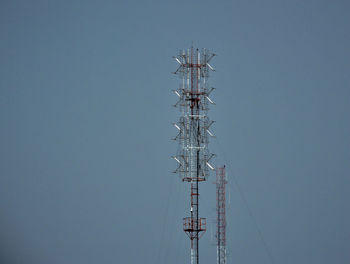 Low angle view of communications tower against sky