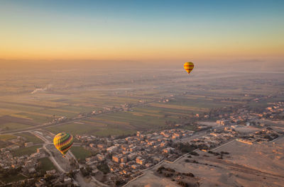 Aerial view of hot air balloon flying over land