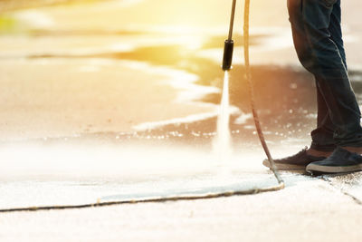 Low section of man standing in water