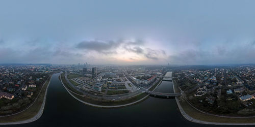 High angle view of buildings against cloudy sky